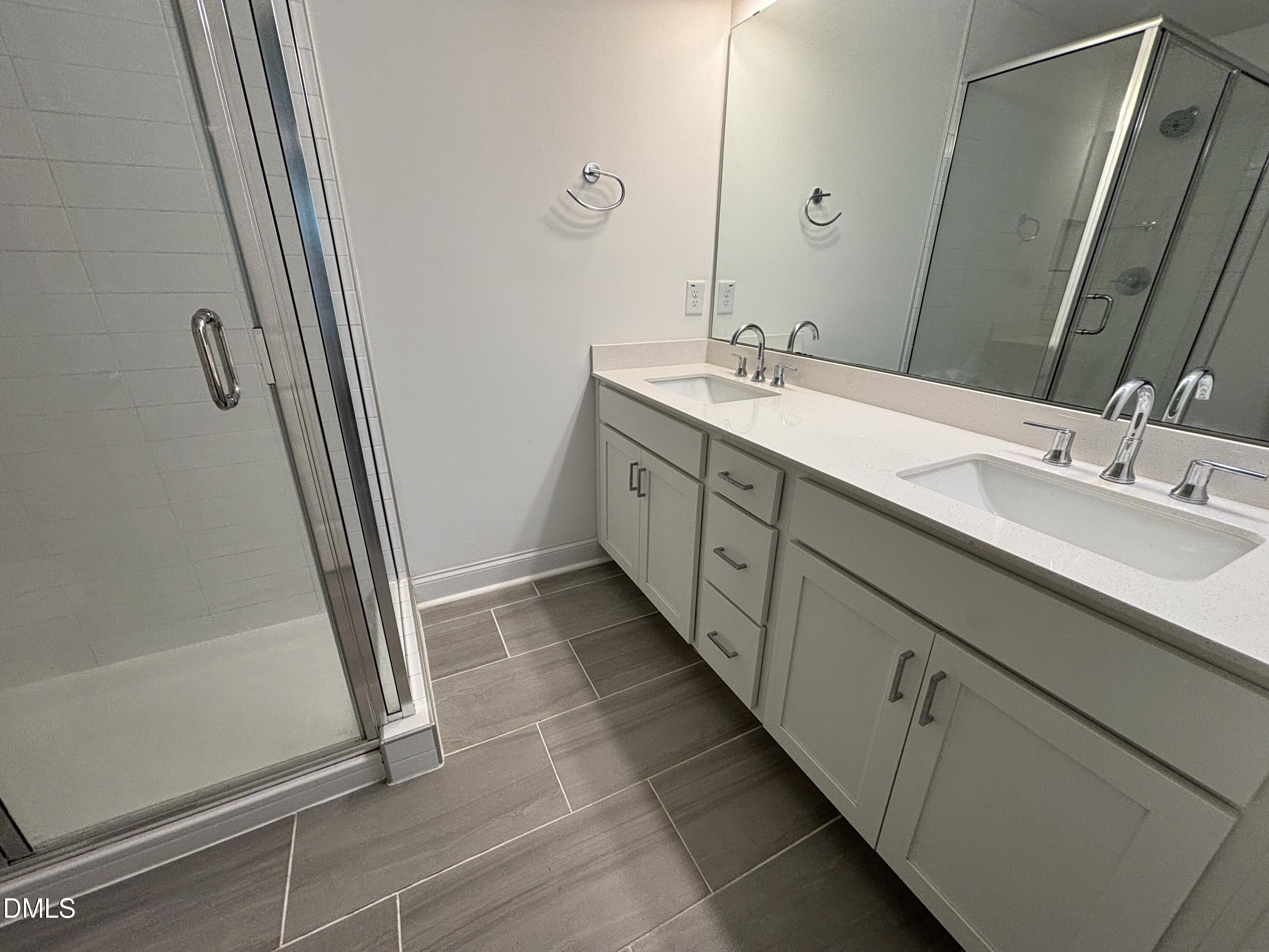 5710 Parker Pnes Court Raleigh, NC 27609 - Photo 50 of 78 a bathroom with a double vanity sink and mirror