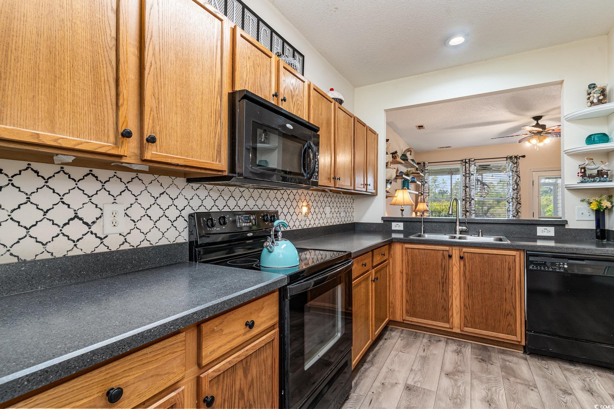316 Kiskadee Loop, Unit 9E Conway, SC 29526 - Photo 12 of 40 Kitchen with light wood-type flooring, backsplash,
