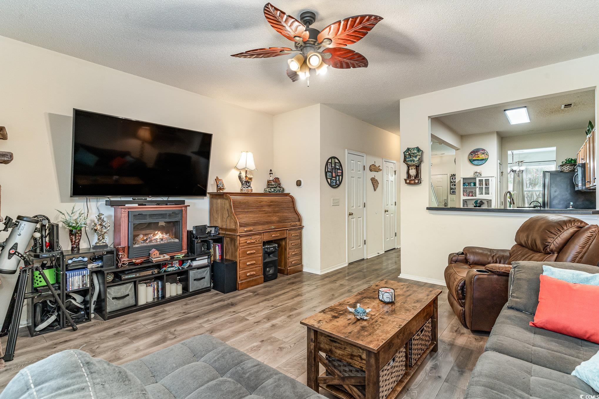 316 Kiskadee Loop, Unit 9E Conway, SC 29526 - Photo 14 of 40 Living room with a textured ceiling, hardwood / wo