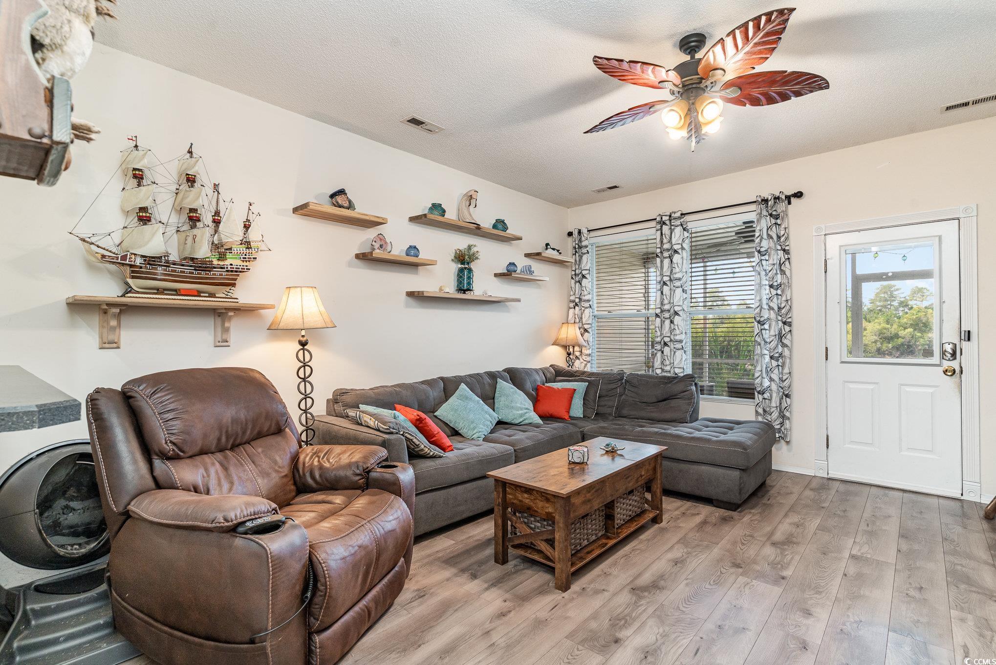 316 Kiskadee Loop, Unit 9E Conway, SC 29526 - Photo 16 of 40 Living room with a textured ceiling, ceiling fan,