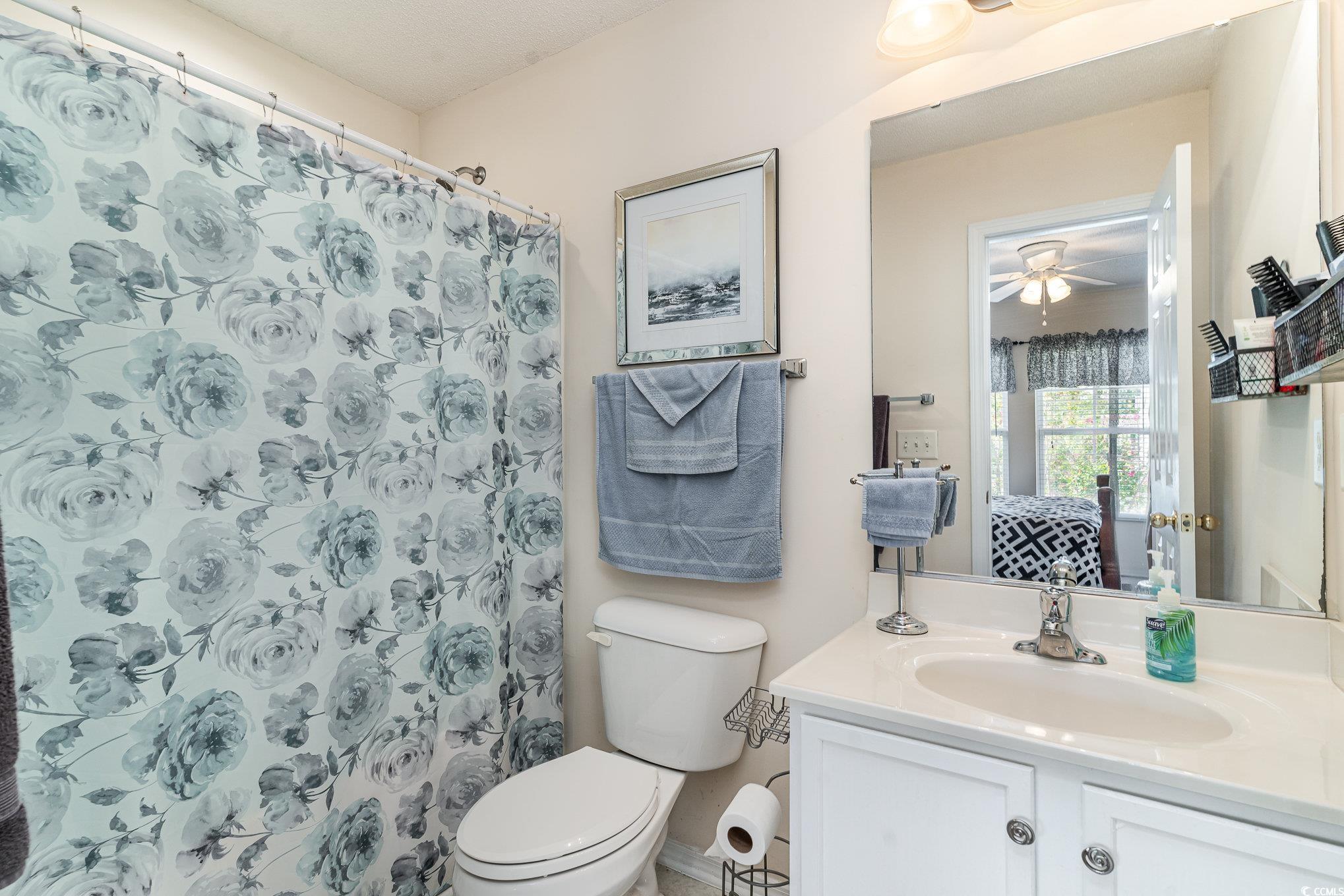 316 Kiskadee Loop, Unit 9E Conway, SC 29526 - Photo 26 of 40 Bathroom with walk in shower, vanity, toilet, and