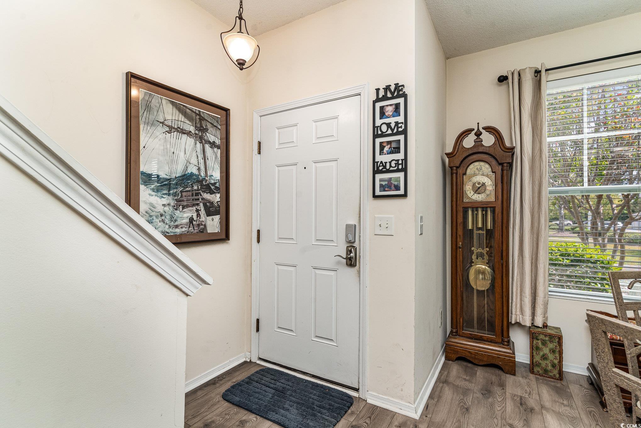 316 Kiskadee Loop, Unit 9E Conway, SC 29526 - Photo 8 of 40 Entryway featuring a textured ceiling and wood-typ