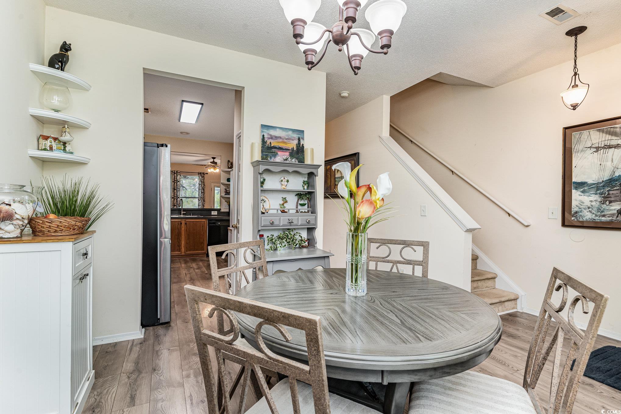 316 Kiskadee Loop, Unit 9E Conway, SC 29526 - Photo 9 of 40 Dining room with a textured ceiling, wood-type flo