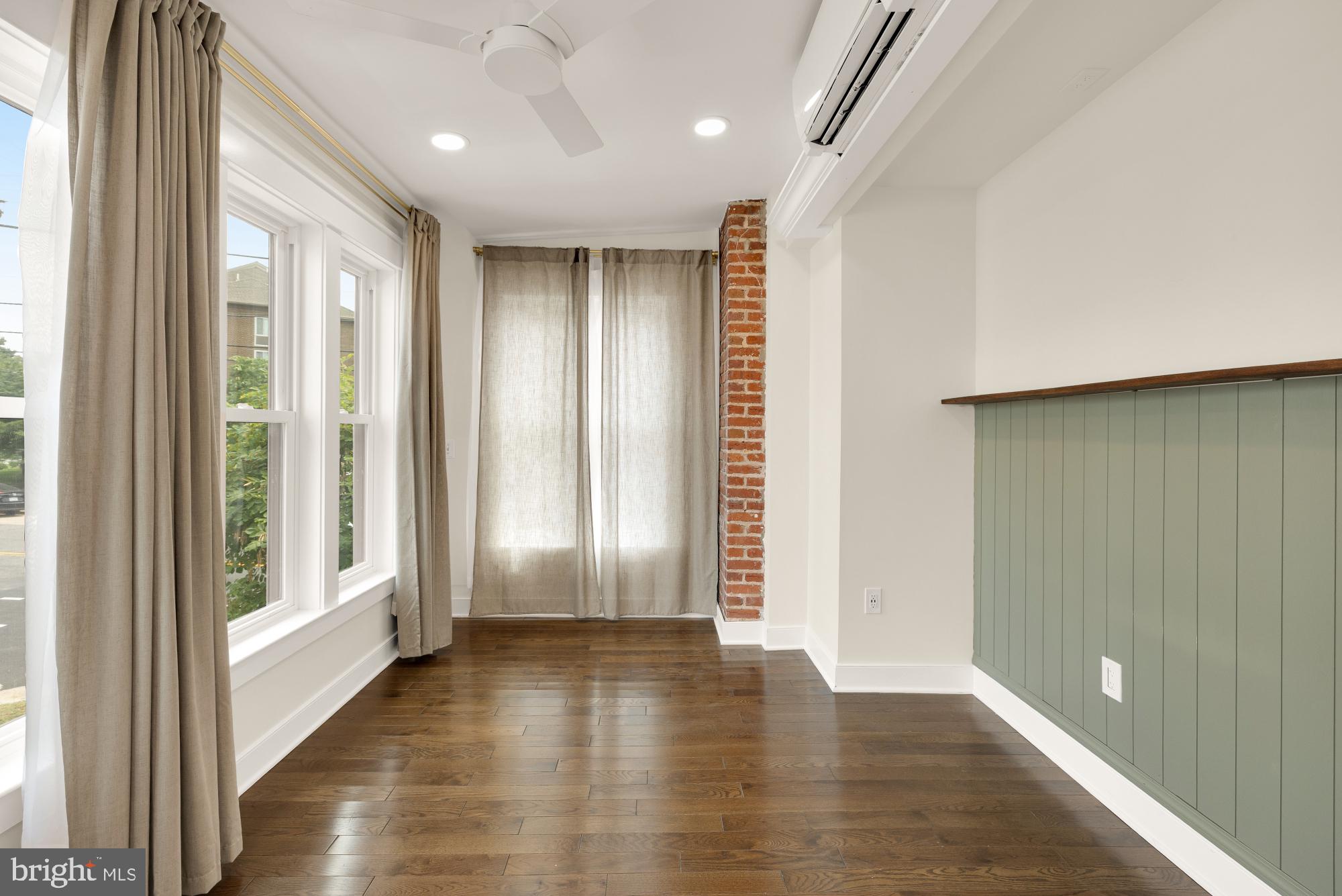 336 Channing Street Northeast, Unit A Washington, DC 20002 - Photo 16 of 28 an empty room with wooden floor and windows