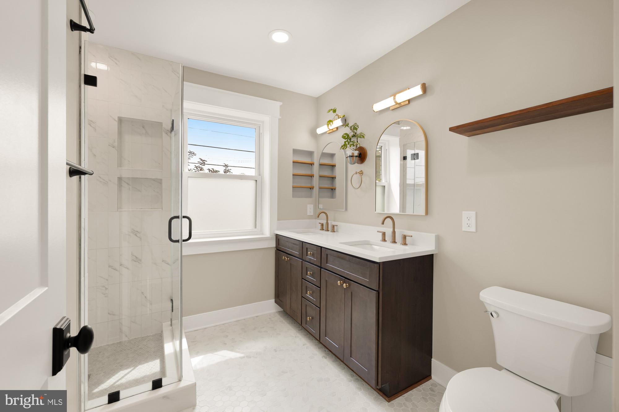 336 Channing Street Northeast, Unit A Washington, DC 20002 - Photo 19 of 28 a bathroom with a double vanity sink toilet mirror and shower