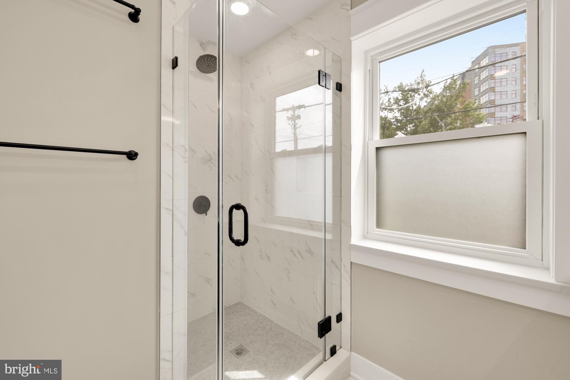 336 Channing Street Northeast, Unit A Washington, DC 20002 - Photo 20 of 28 a bathroom with a glass shower door