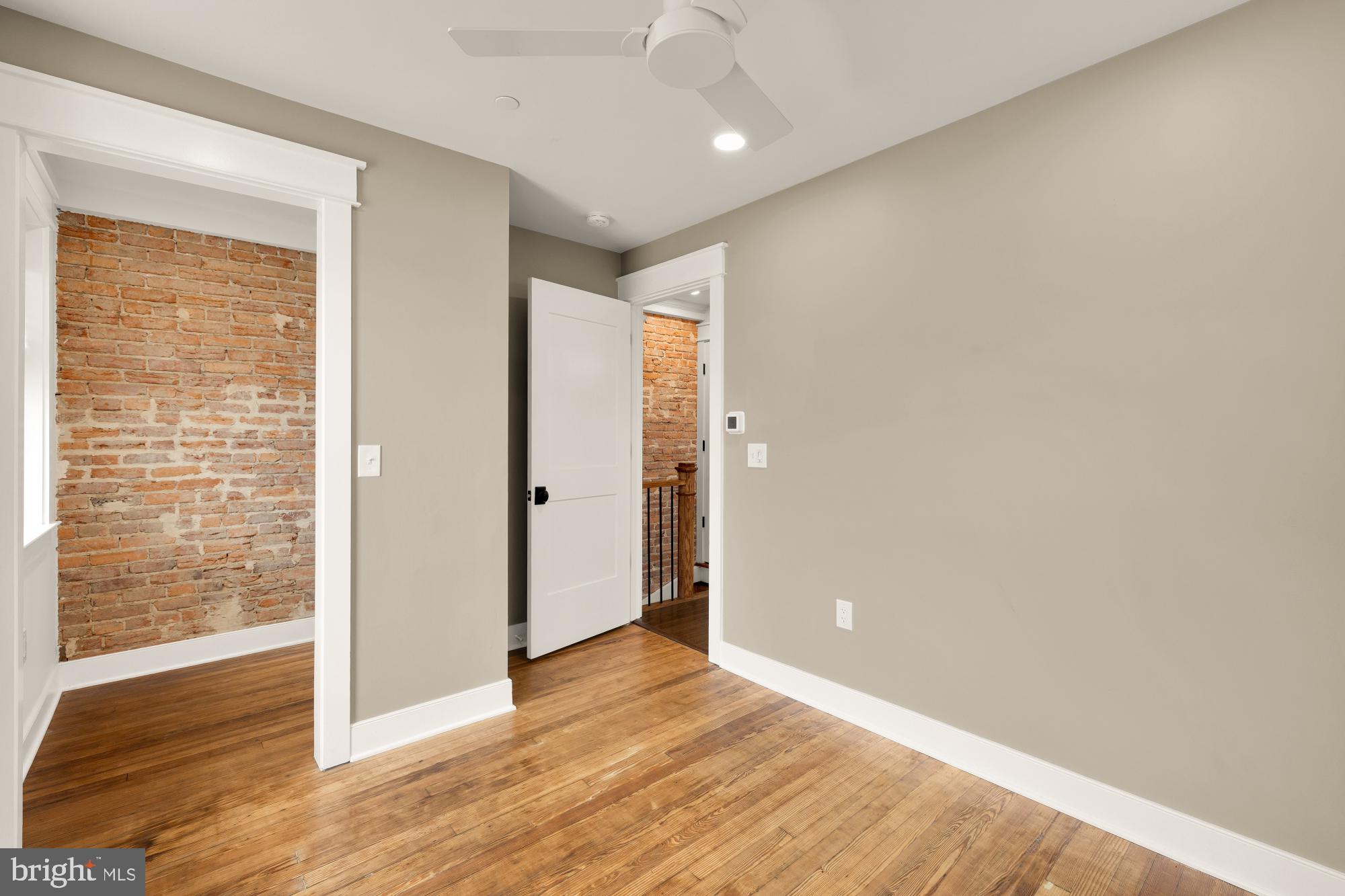 336 Channing Street Northeast, Unit A Washington, DC 20002 - Photo 23 of 28 an empty room with wooden floor and door
