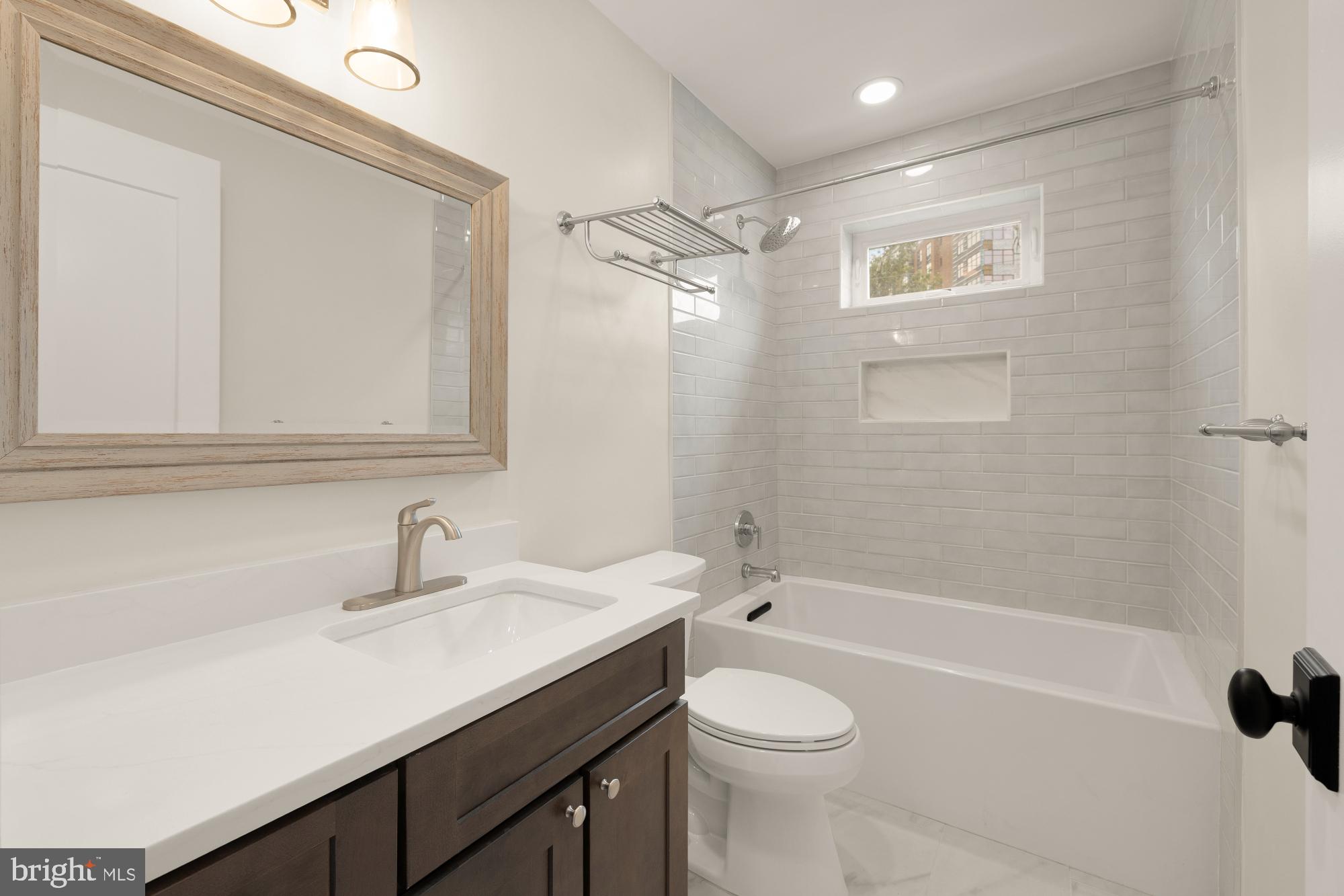 336 Channing Street Northeast, Unit A Washington, DC 20002 - Photo 27 of 28 a bathroom with a sink a toilet and shower