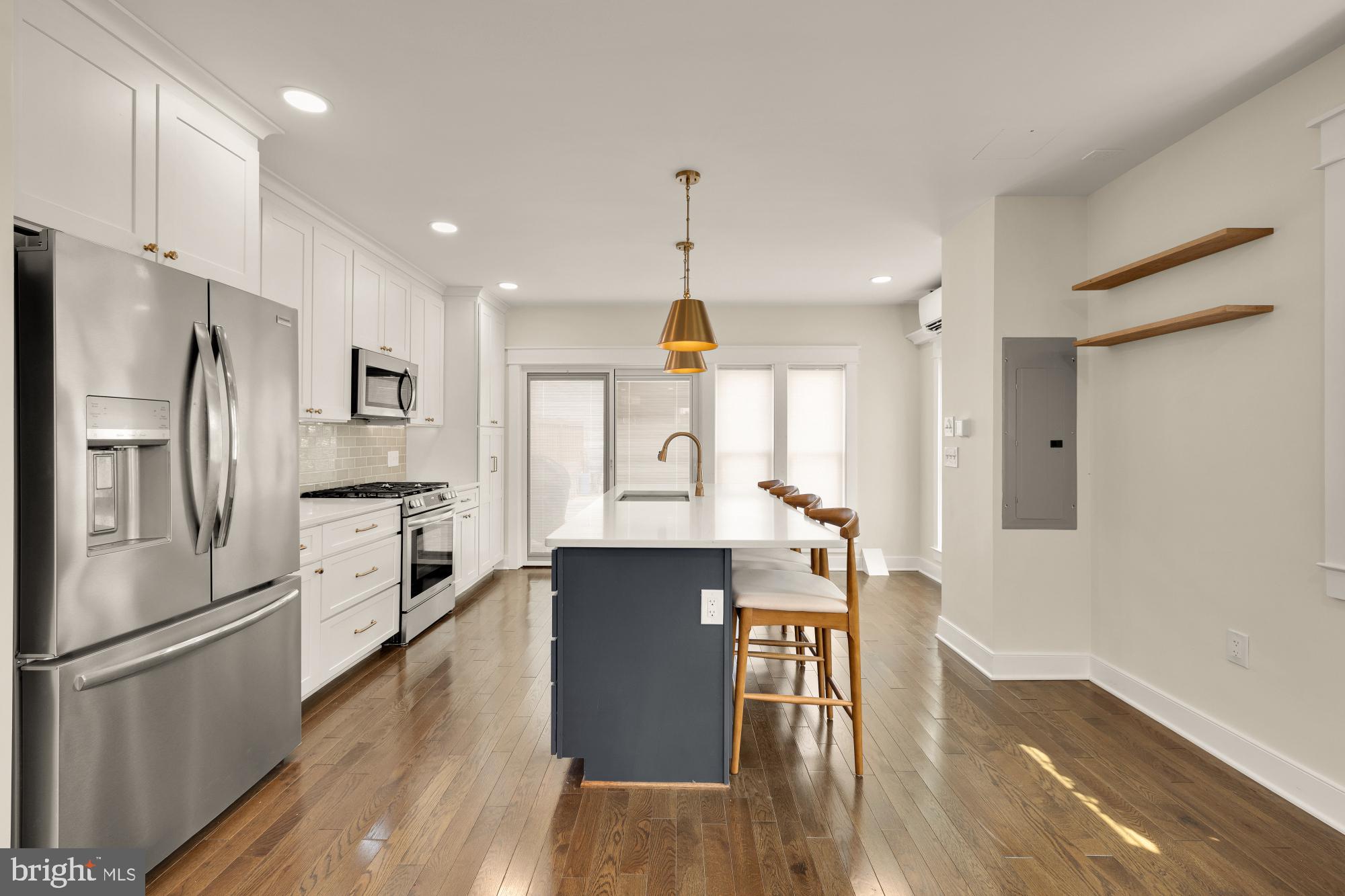 336 Channing Street Northeast, Unit A Washington, DC 20002 - Photo 7 of 28 a kitchen with stainless steel appliances granite countertop a refrigerator a stove top oven a sink dishwasher and white cabinets with wooden floor