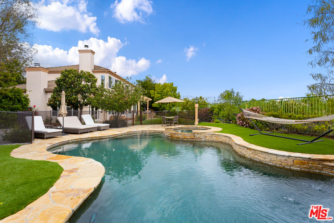 a view of a swimming pool with a table and chairs