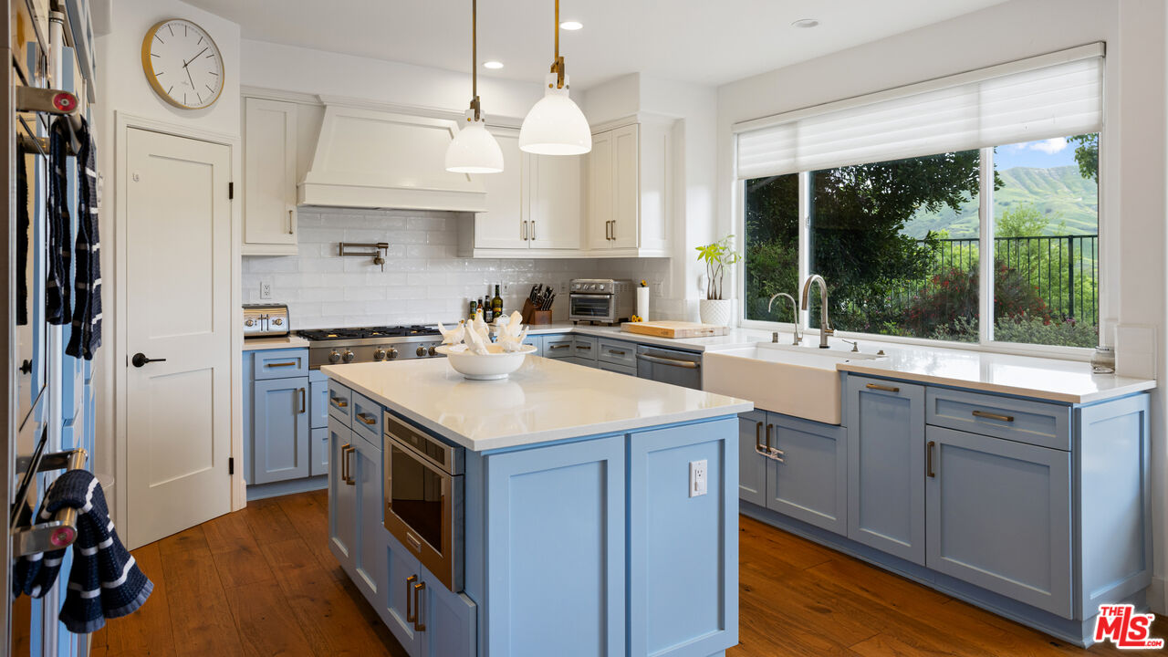 3910 Leighton Point Road Calabasas, CA 91301 - Photo 11 of 29 a kitchen with a stove and a sink