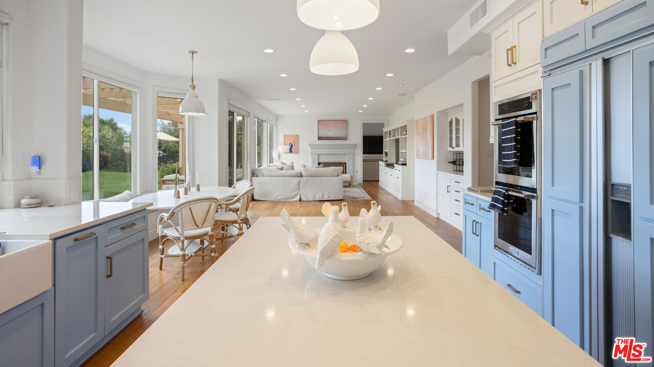 3910 Leighton Point Road Calabasas, CA 91301 - Photo 12 of 29 a large kitchen with a large window and stainless steel appliances