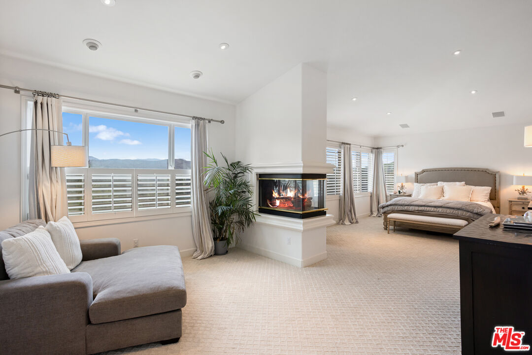 3910 Leighton Point Road Calabasas, CA 91301 - Photo 15 of 29 a living room with furniture and a fireplace