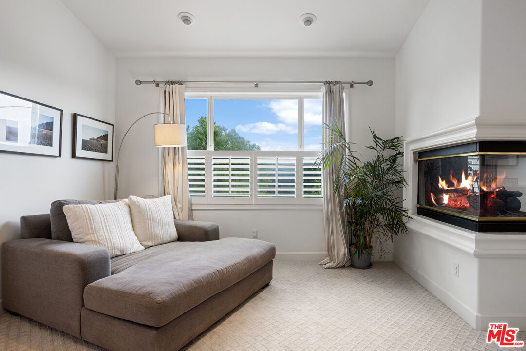 3910 Leighton Point Road Calabasas, CA 91301 - Photo 16 of 29 a living room with furniture a flat screen tv and a large window