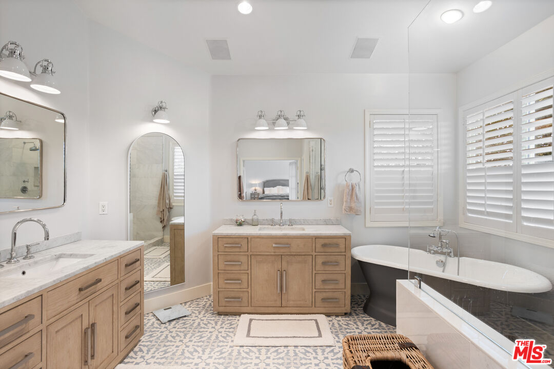 3910 Leighton Point Road Calabasas, CA 91301 - Photo 17 of 29 a spacious bathroom with a double vanity sink mirror and bathtub