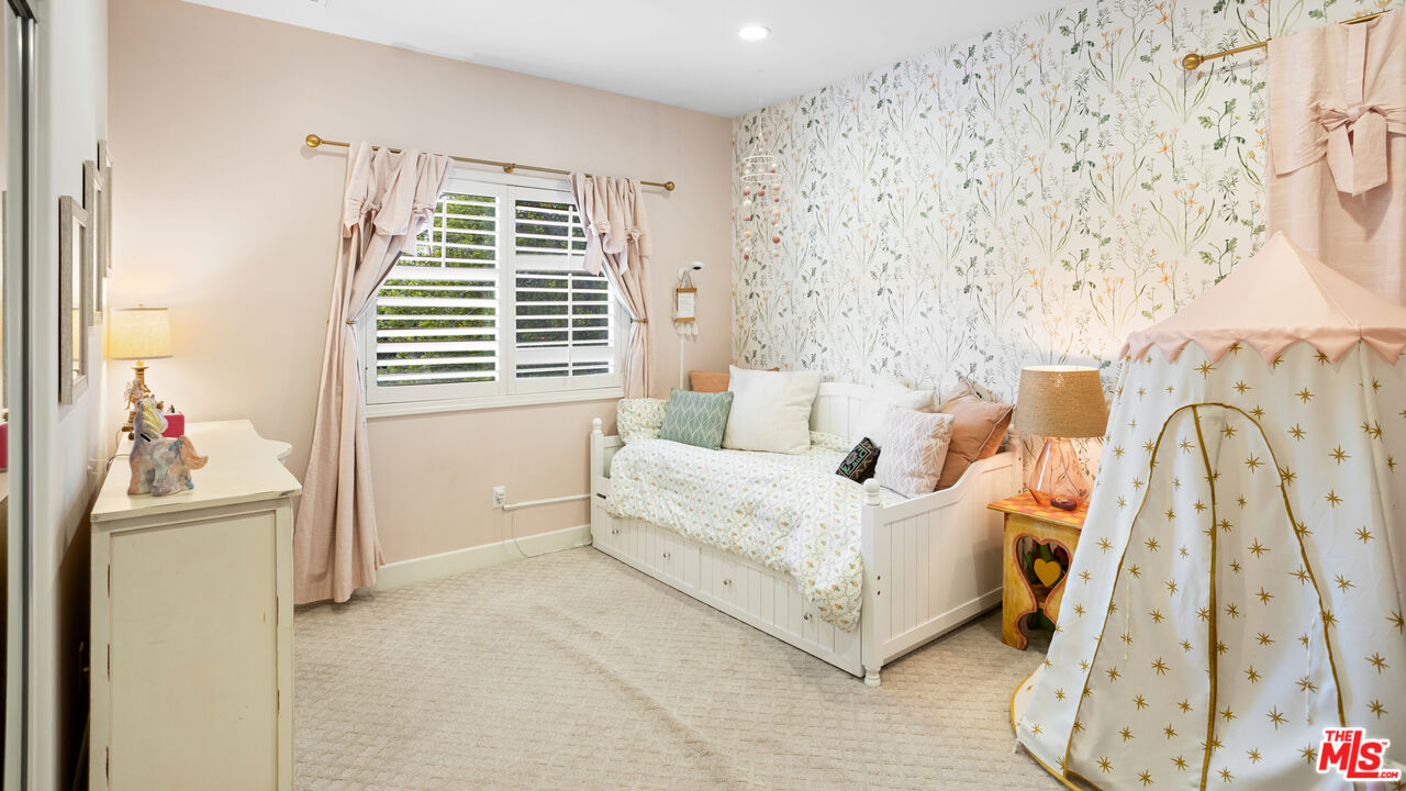 3910 Leighton Point Road Calabasas, CA 91301 - Photo 21 of 29 a bedroom with a bed and a window