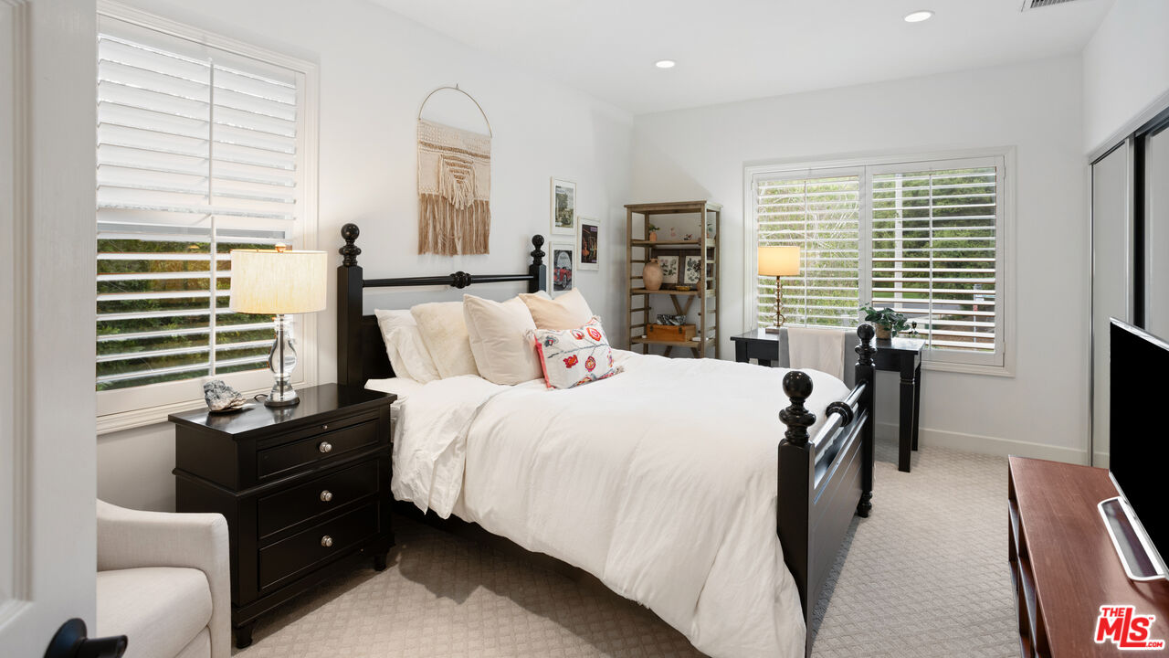 3910 Leighton Point Road Calabasas, CA 91301 - Photo 22 of 29 a bedroom with a bed and a flat tv screen