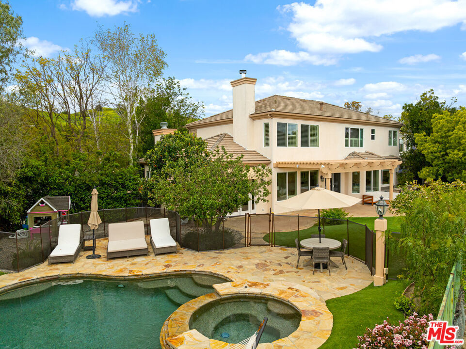 3910 Leighton Point Road Calabasas, CA 91301 - Photo 25 of 29 a view of a house with swimming pool and sitting area