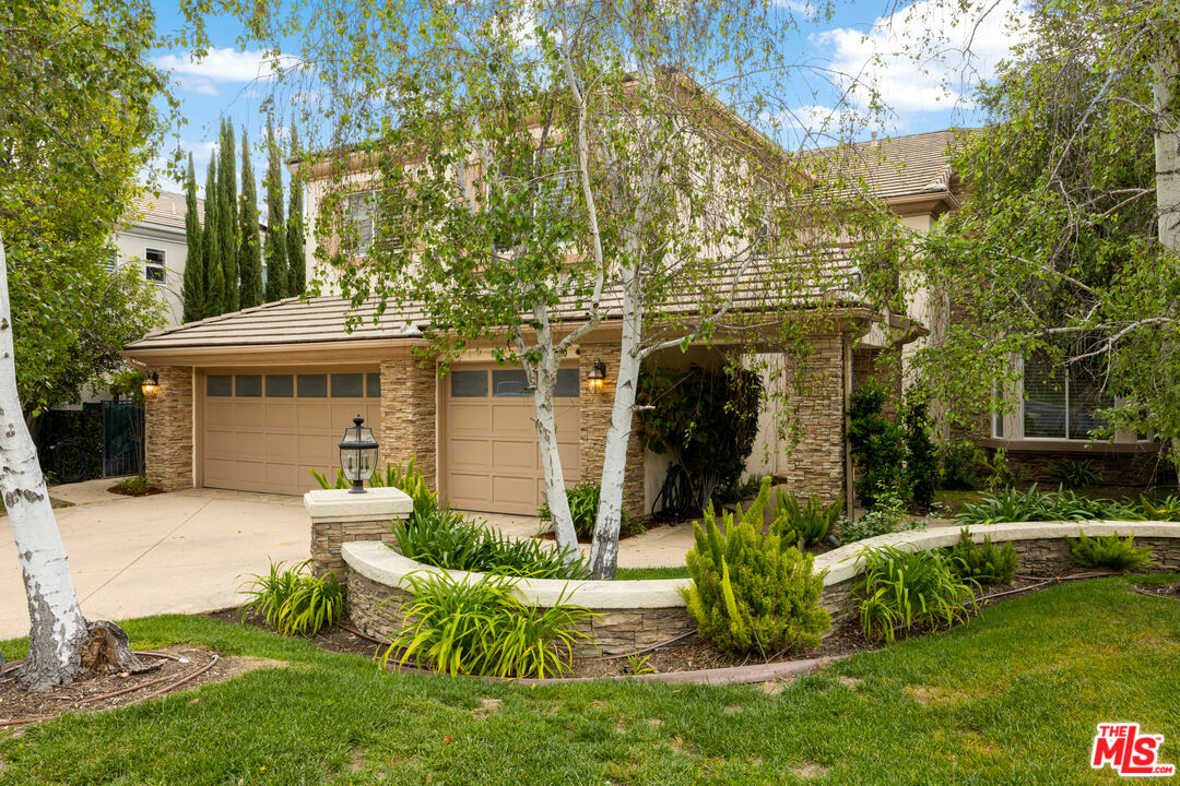 3910 Leighton Point Road Calabasas, CA 91301 - Photo 3 of 29 a front view of a house with garden