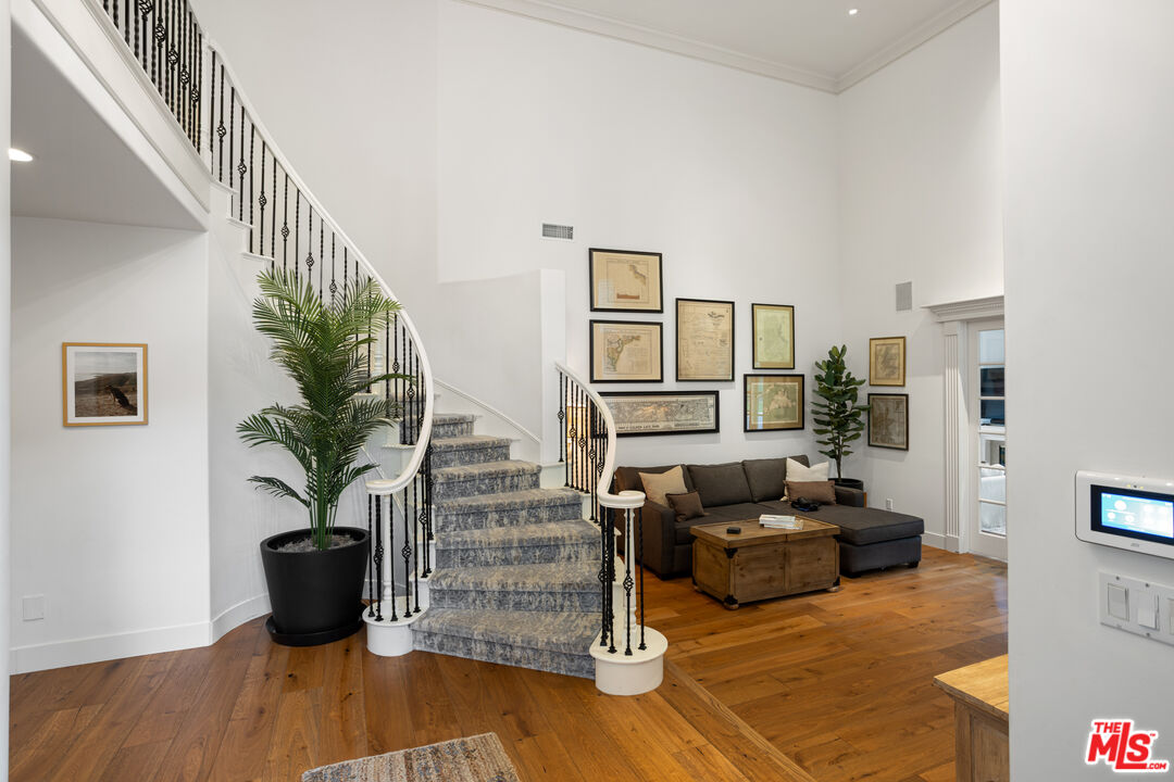 3910 Leighton Point Road Calabasas, CA 91301 - Photo 4 of 29 a living room with furniture wooden floor and a potted plant