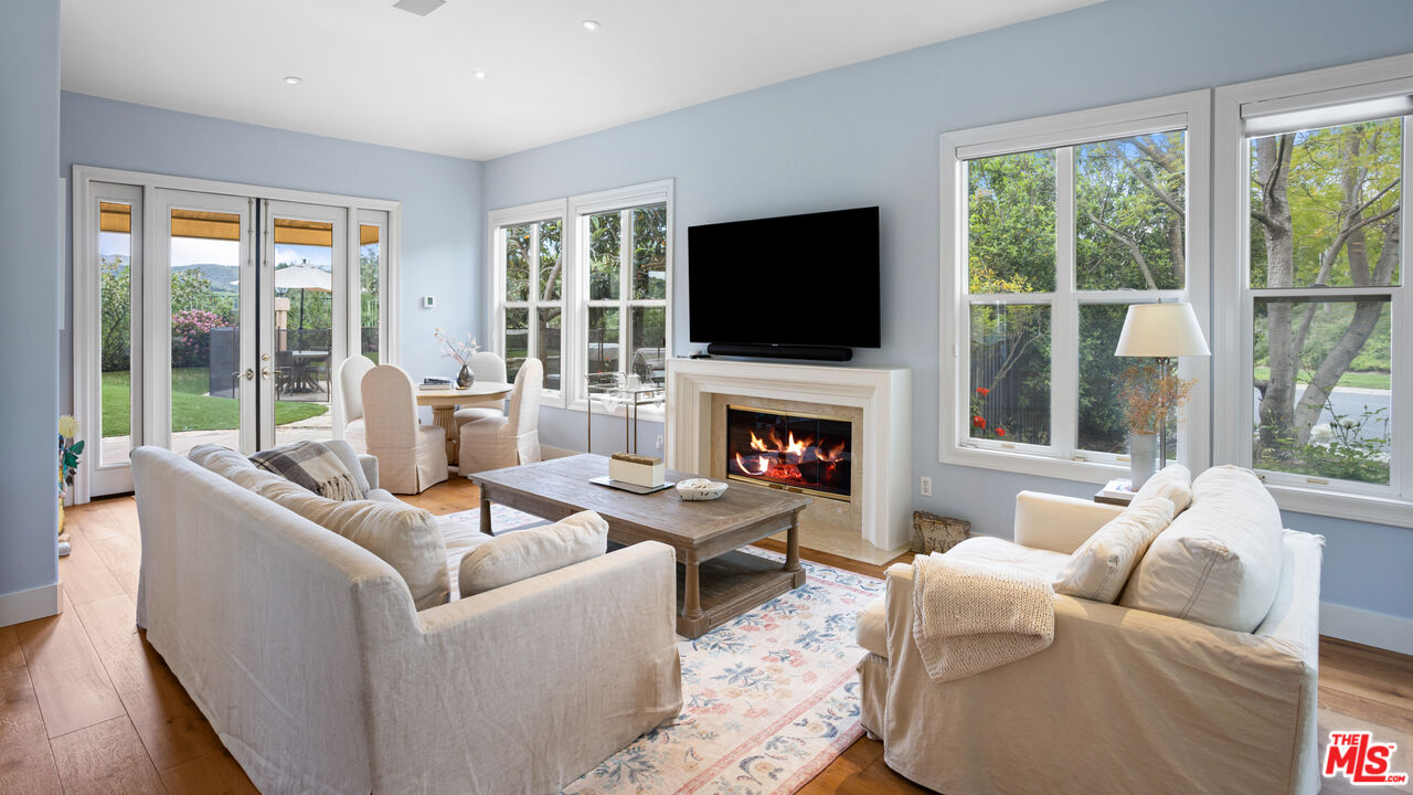 3910 Leighton Point Road Calabasas, CA 91301 - Photo 7 of 29 a living room with furniture a fireplace and a flat screen tv