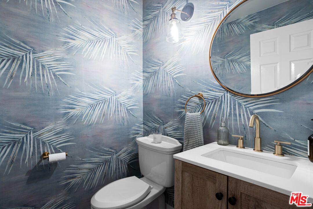 3910 Leighton Point Road Calabasas, CA 91301 - Photo 8 of 29 a bathroom with a sink a toilet and a mirror