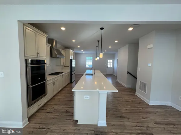 a kitchen with kitchen island a counter top space a stove and refrigerator