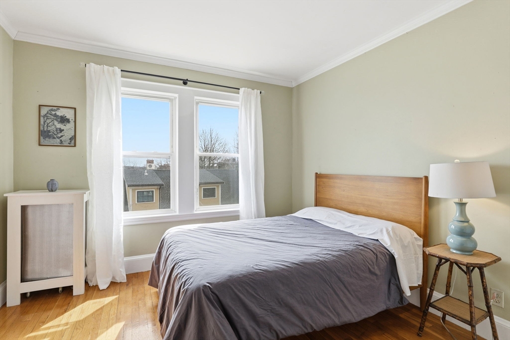 85 Jamaica Street, Unit 3 Boston, MA 02130 - Photo 12 of 19 a bedroom with a bed and a window