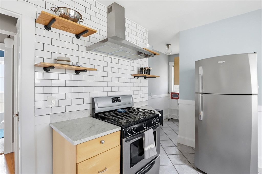 85 Jamaica Street, Unit 3 Boston, MA 02130 - Photo 3 of 19 a kitchen with a stove a refrigerator and a sink