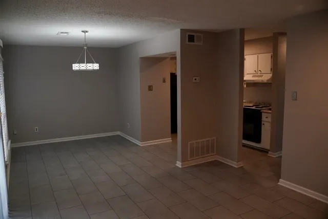 an empty room with closet and a bathroom
