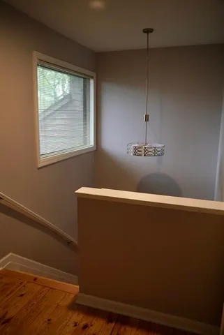 a view of a closet with wooden floor
