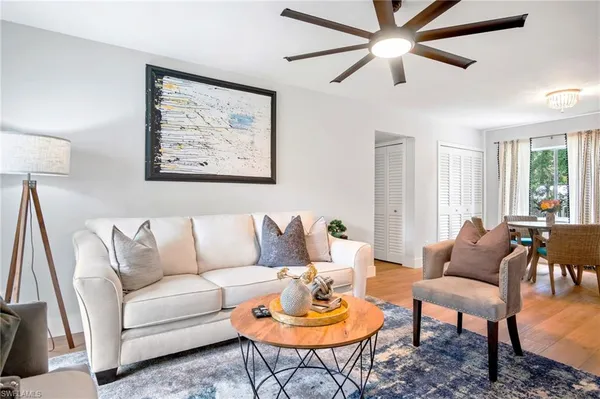 a living room with furniture a rug and a window
