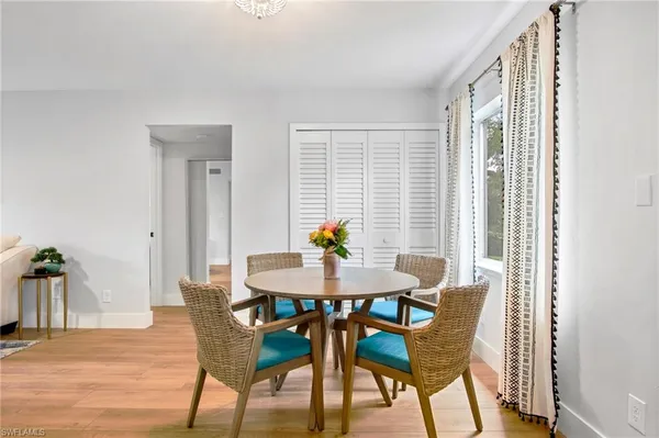 a view of a dining room with furniture and a potted plant
