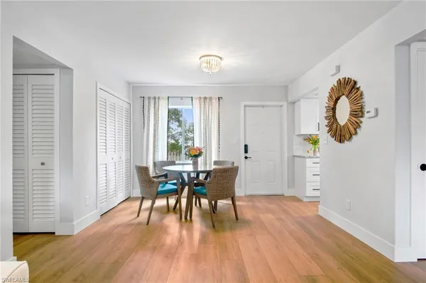 a view of a dining room with furniture and wooden floor