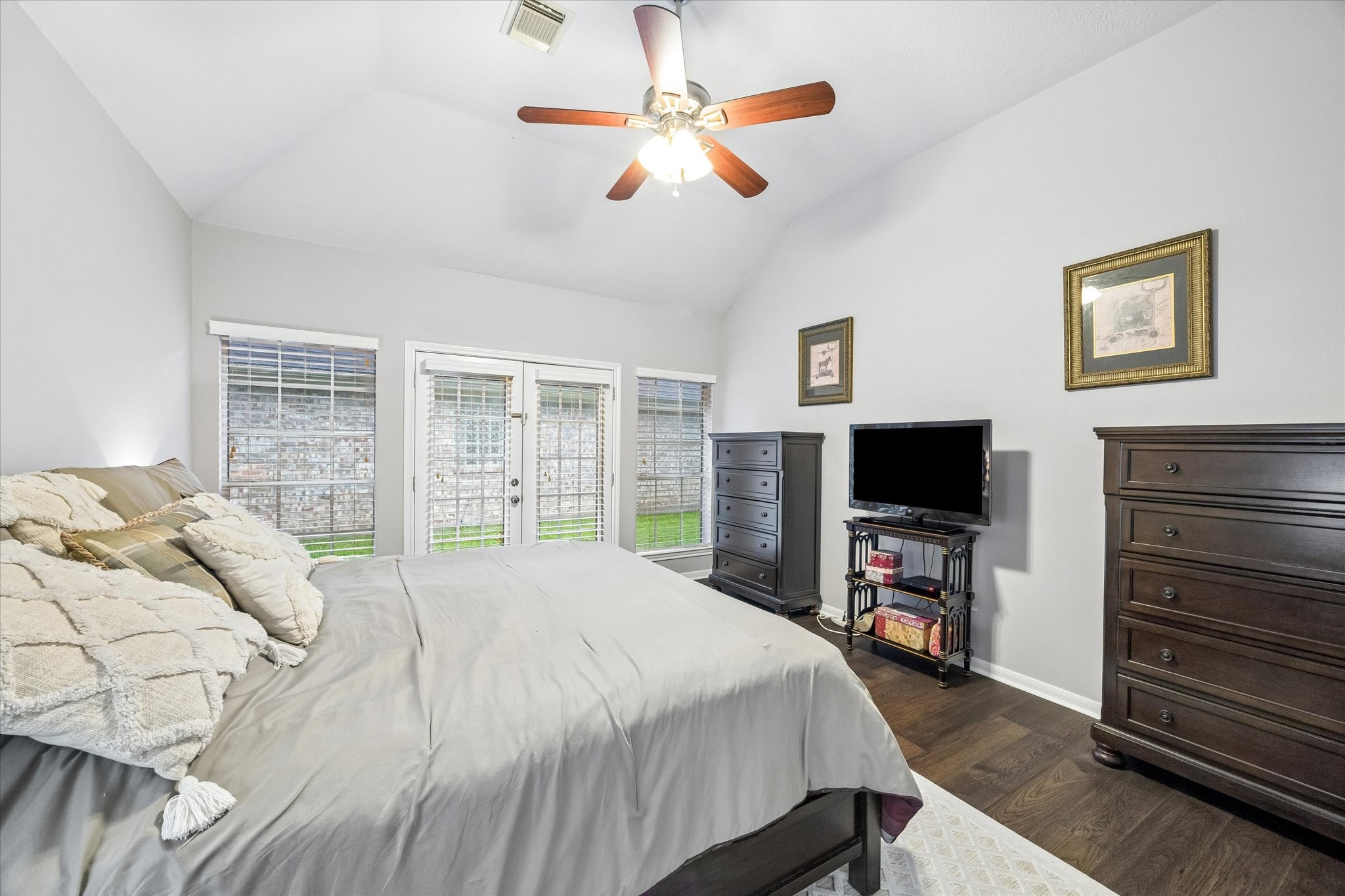 12423 Rutgers Park Court Houston, TX 77058 - Photo 24 of 29 a bedroom with a bed flat screen tv and a large window