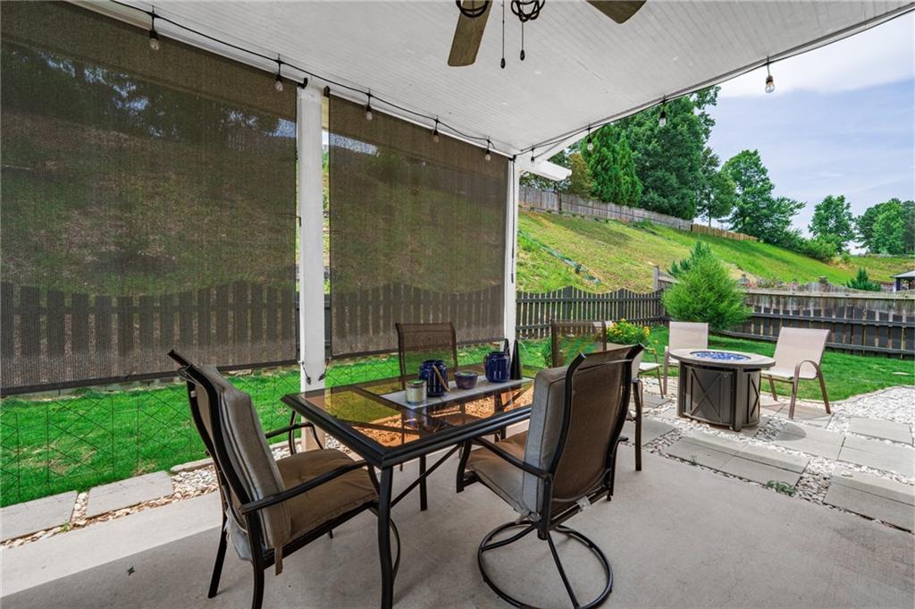 230 Augusta Walk Canton, GA 30114 - Photo 43 of 56 a view of a patio with a table chairs and a backyard