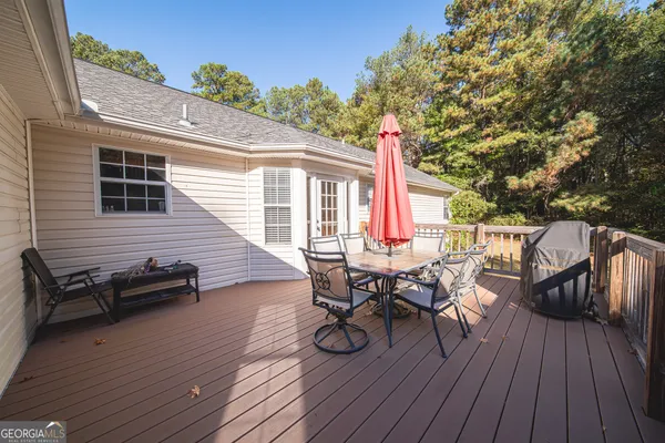 a view of a patio with table and chairs and wooden floor
