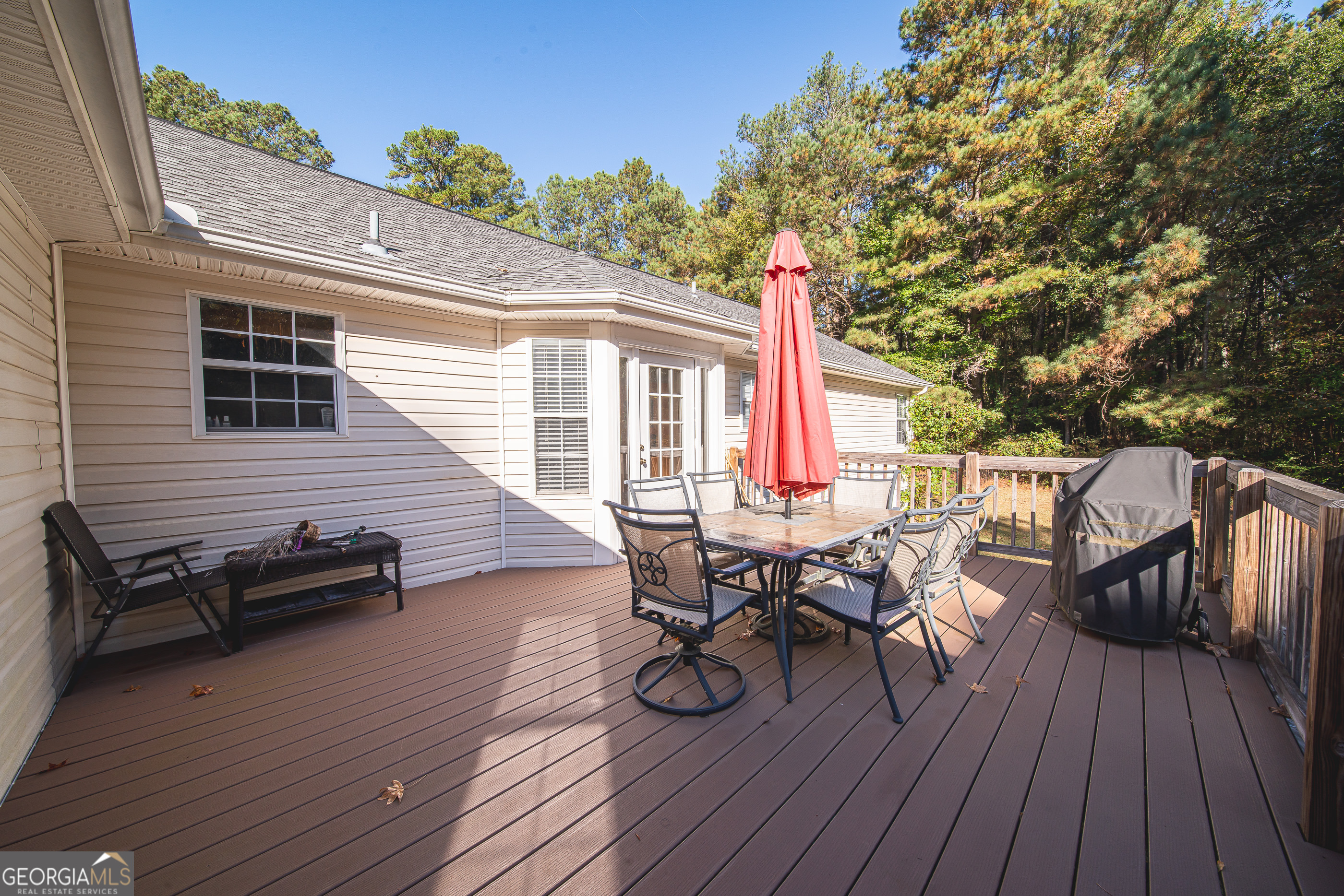 200 Lake Amah Lee Road Hampton, GA 30228 - Photo 11 of 37 a view of a patio with table and chairs and wooden floor