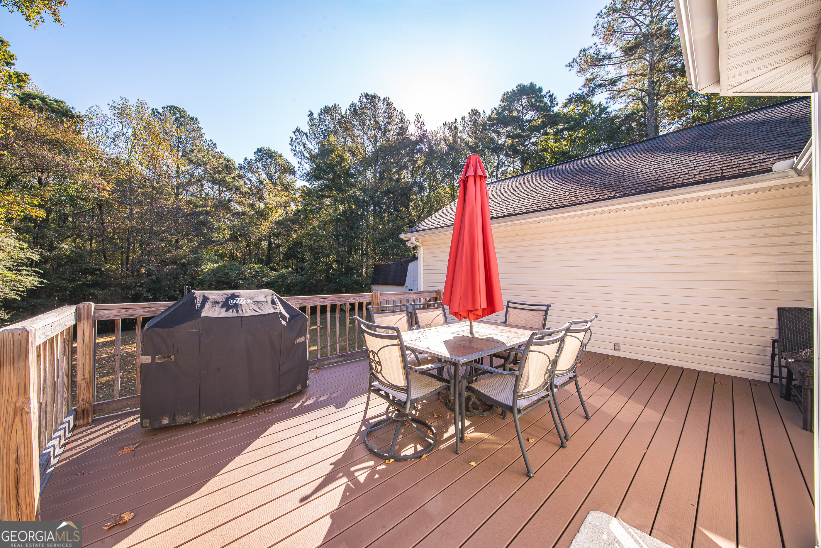 200 Lake Amah Lee Road Hampton, GA 30228 - Photo 12 of 37 a view of a roof deck with table and chairs with wooden floor and fence