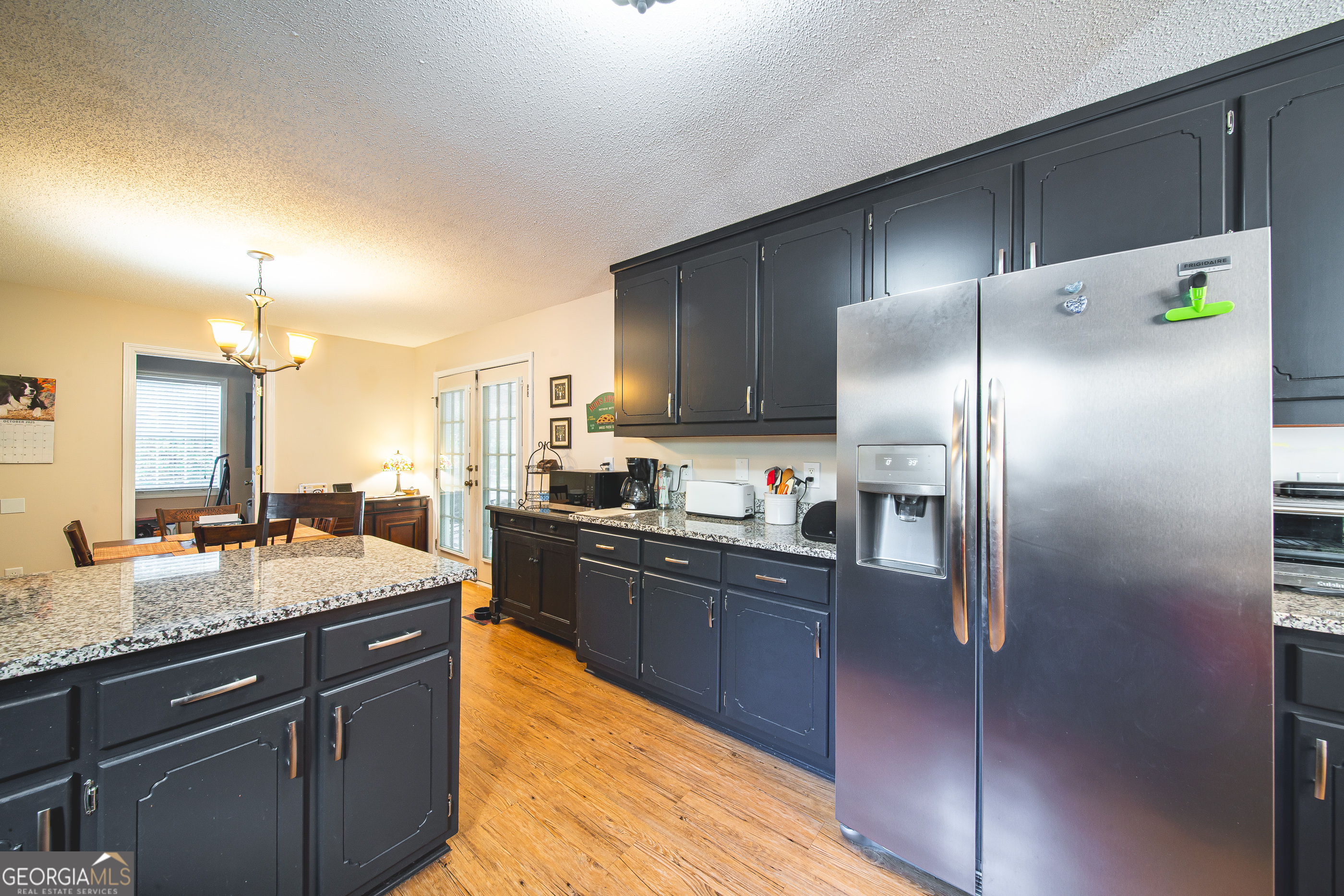200 Lake Amah Lee Road Hampton, GA 30228 - Photo 23 of 37 a kitchen with stainless steel appliances granite countertop a sink a stove and refrigerator