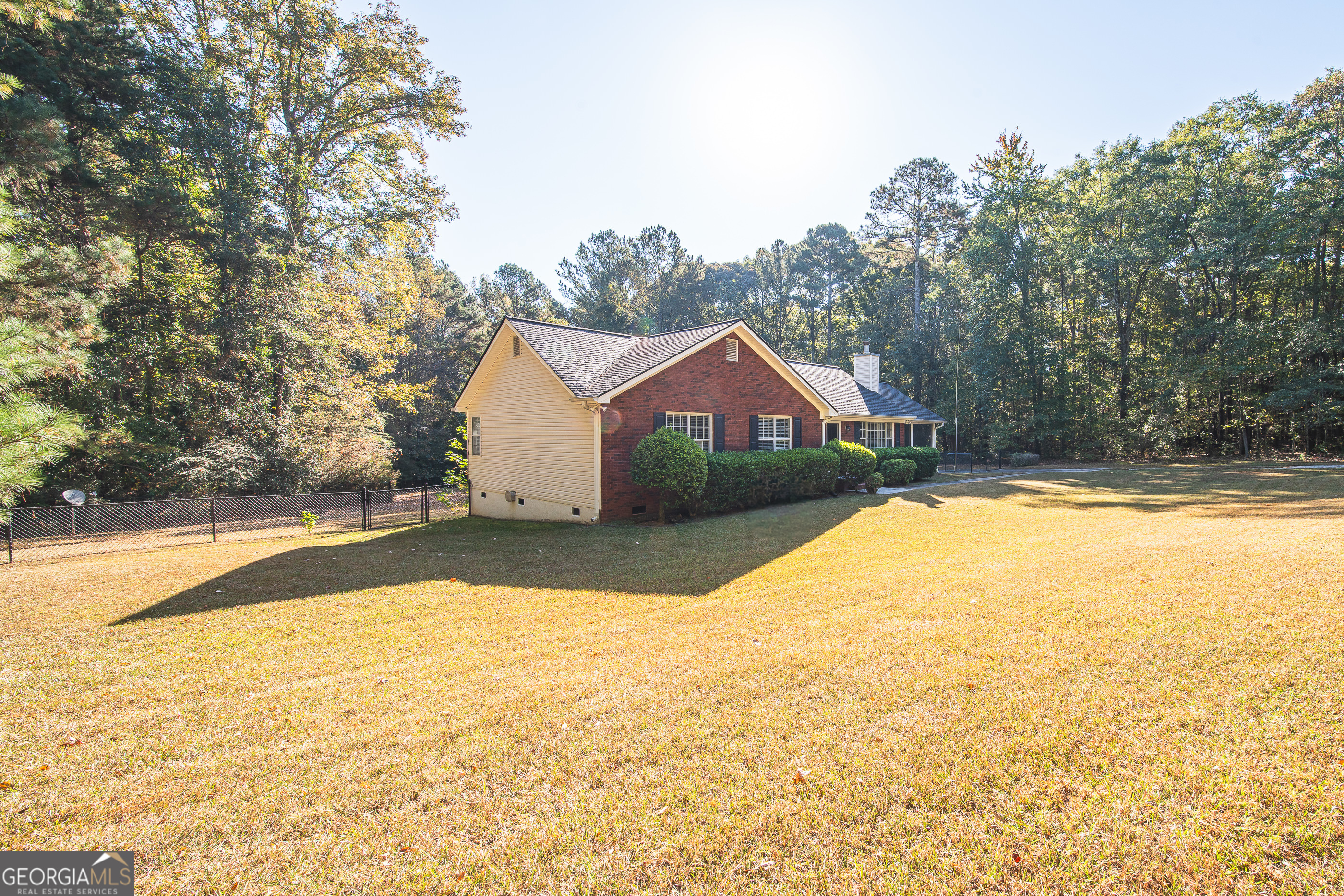 200 Lake Amah Lee Road Hampton, GA 30228 - Photo 25 of 37 a front view of house with yard and trees in the background