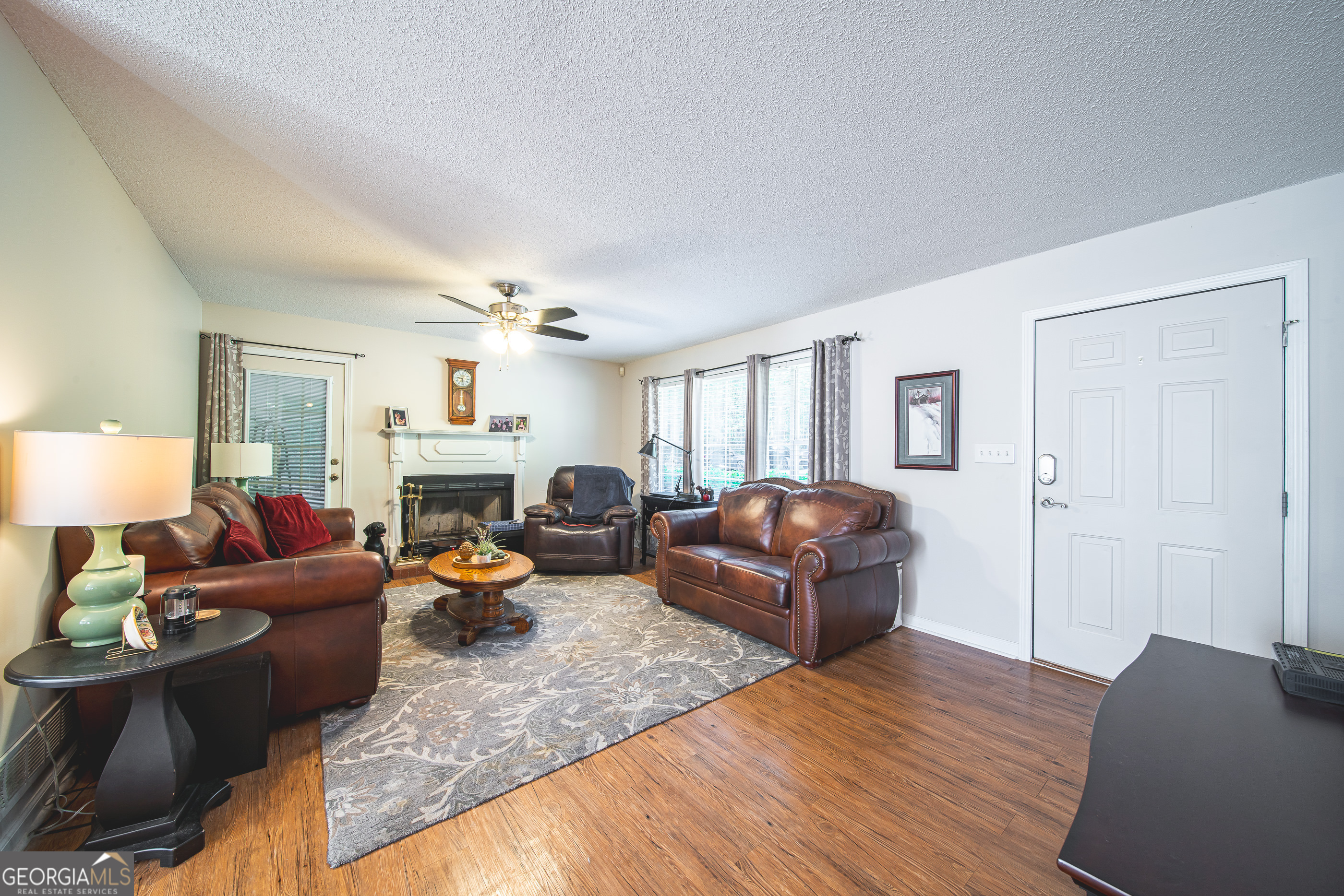 200 Lake Amah Lee Road Hampton, GA 30228 - Photo 26 of 37 a living room with furniture and a wooden floor