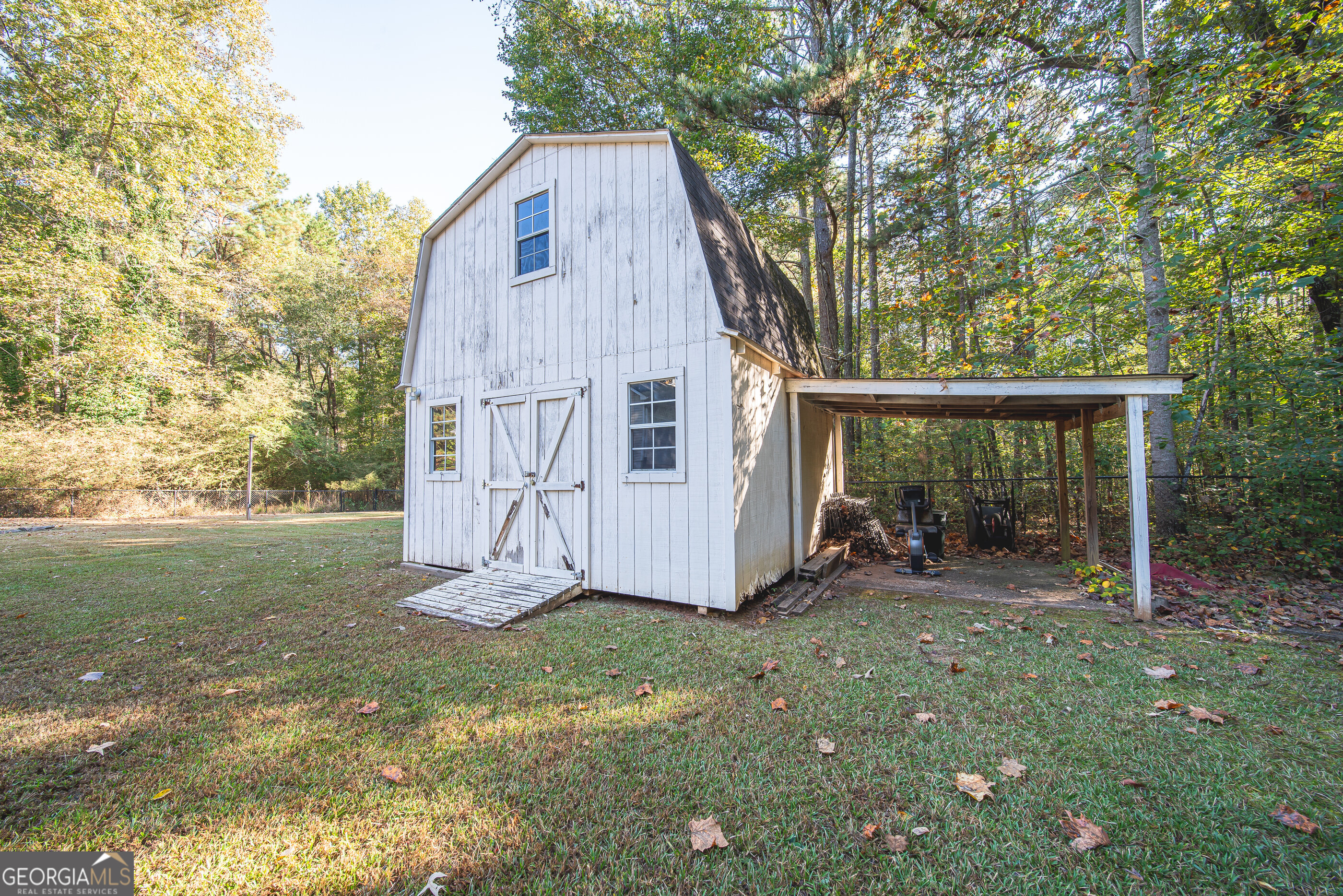 200 Lake Amah Lee Road Hampton, GA 30228 - Photo 5 of 37 a view of backyard with small cabin