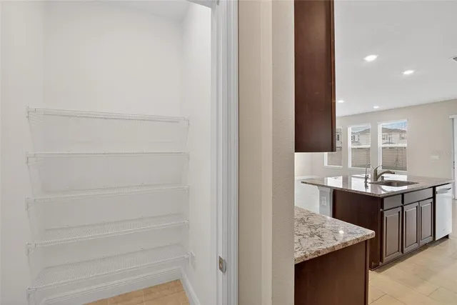 a living room with stainless steel appliances kitchen island granite countertop a refrigerator and a stove top oven