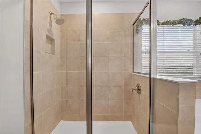 a view of a house with a big yard and large trees