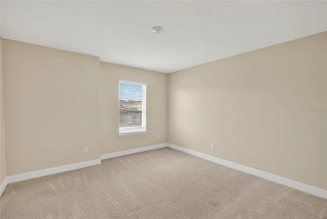 a view of a swimming pool with lawn chairs