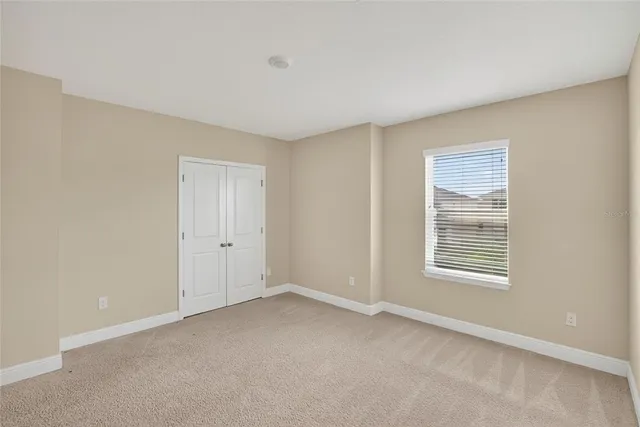 an aerial view of a house with garden space and street view