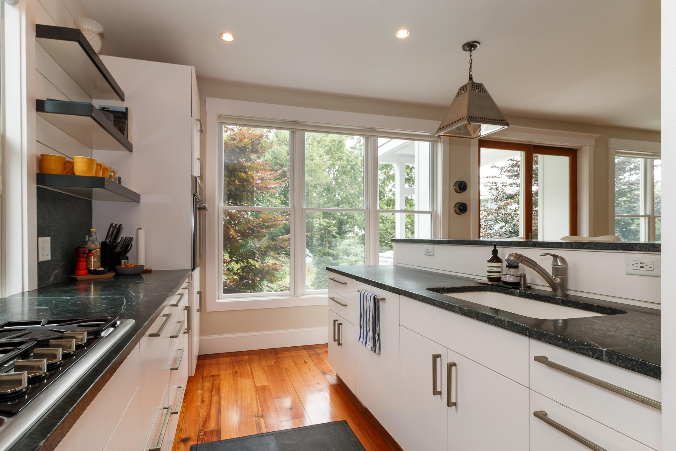 52 Point Street Provincetown, MA 02657 - Photo 13 of 35 a kitchen with counter top space a sink and appliances