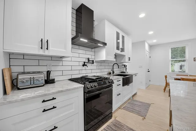 a kitchen with stainless steel appliances granite countertop a stove a sink and a refrigerator