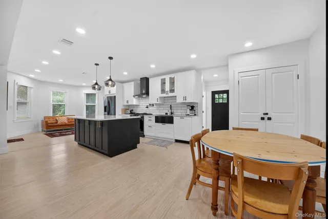 a large kitchen with a table and chairs